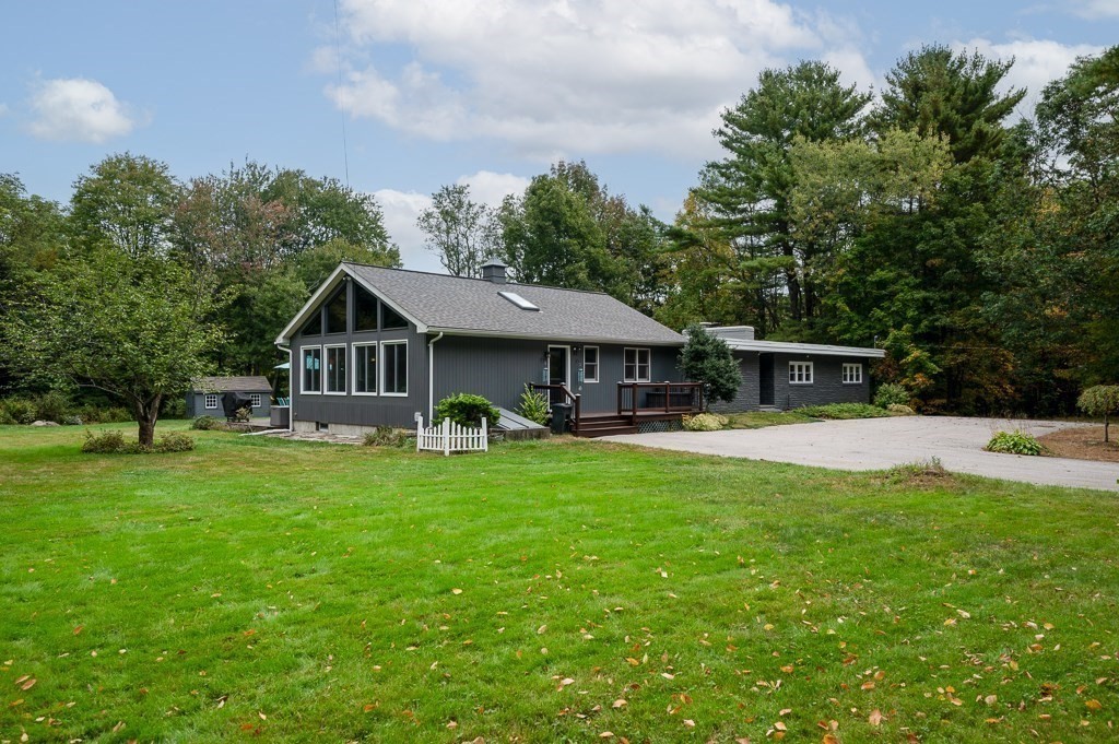 a front view of a house with yard patio and green space