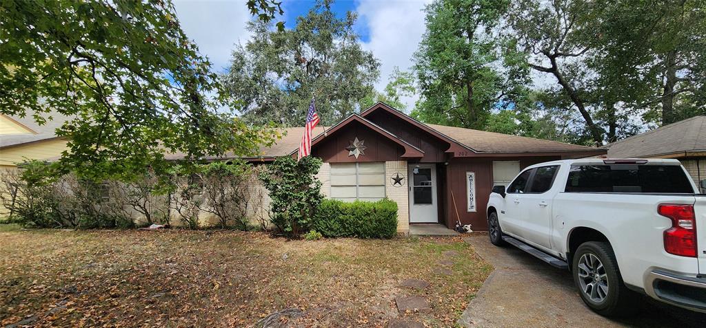 a view of a house with a yard and garage