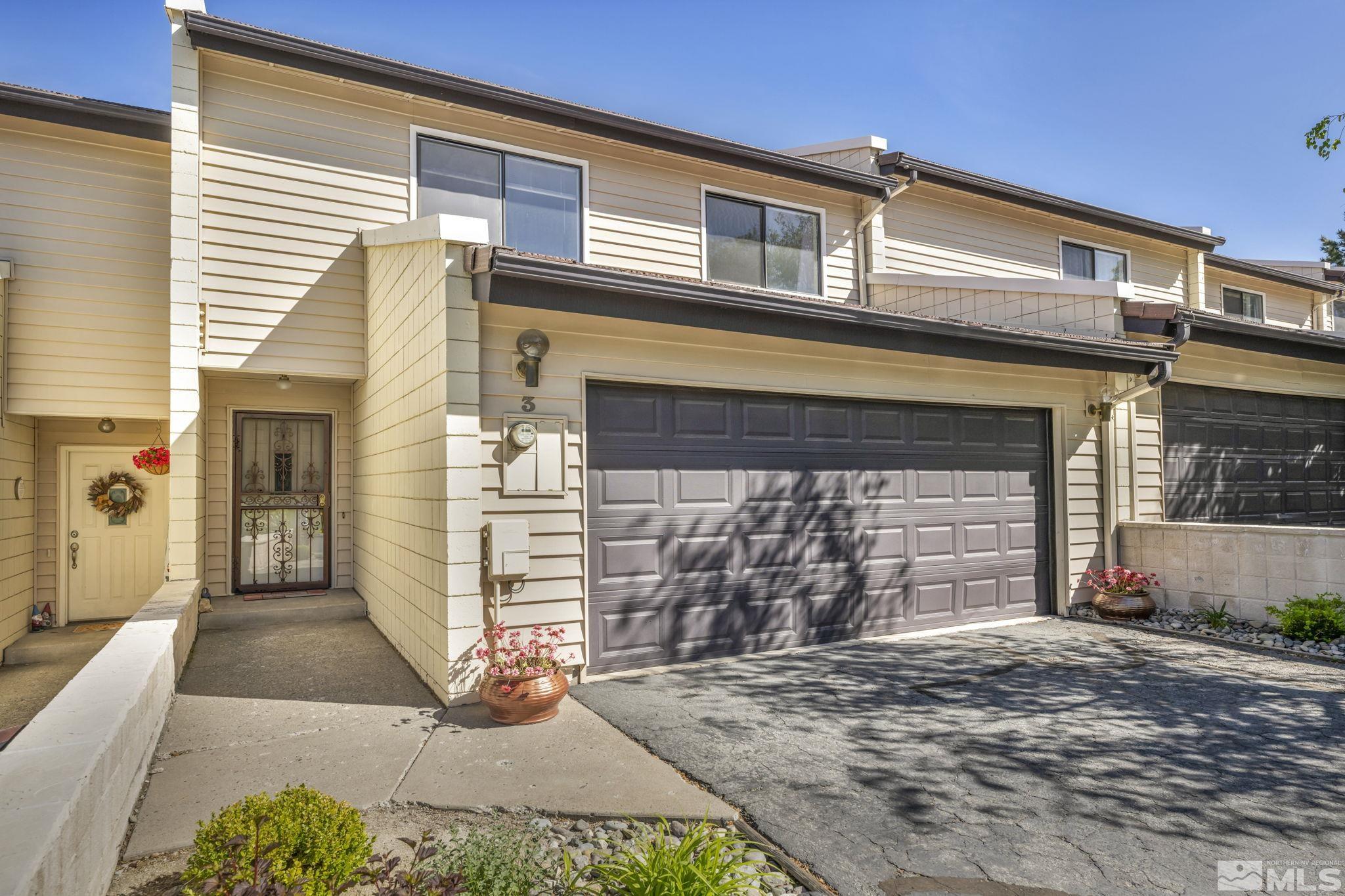 a front view of a house with garage