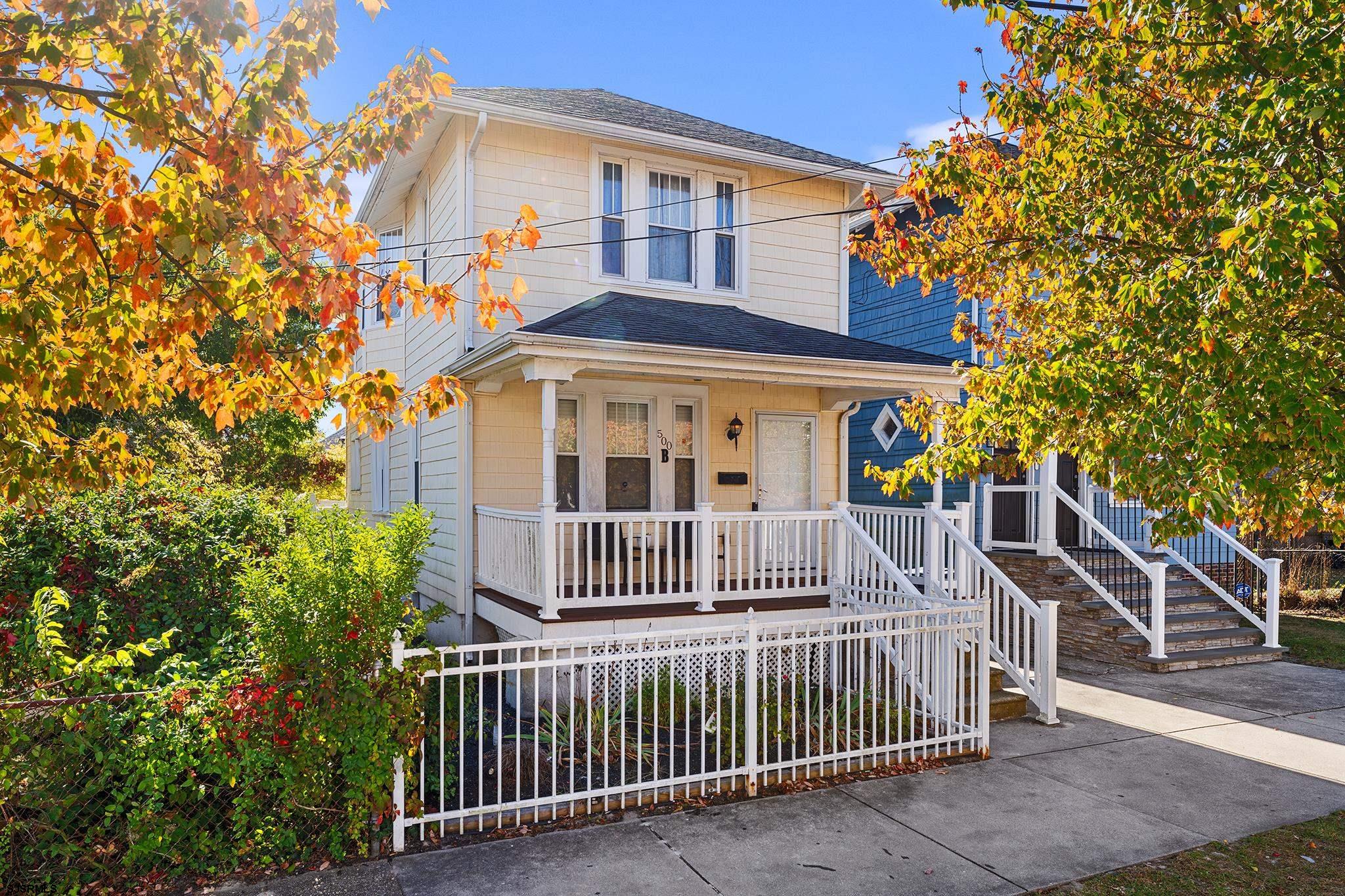 a front view of a house with iron fence