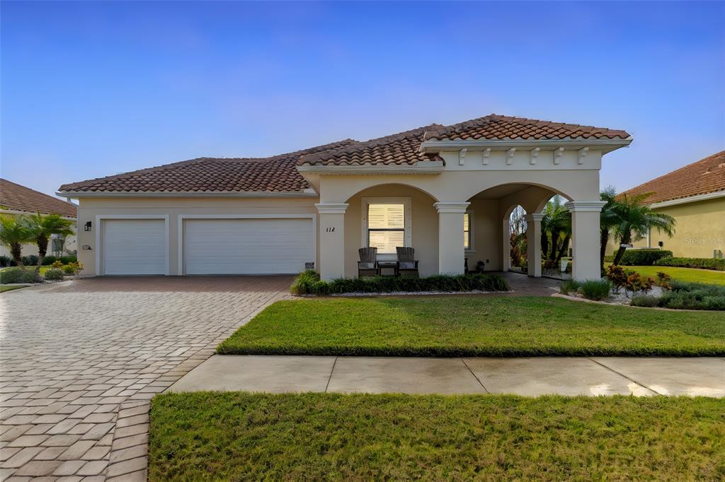 a front view of a house with a garden