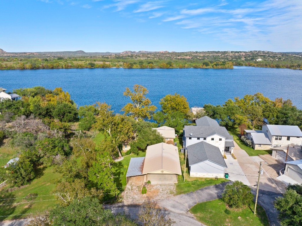 an aerial view of ocean with residential houses with outdoor space and seating