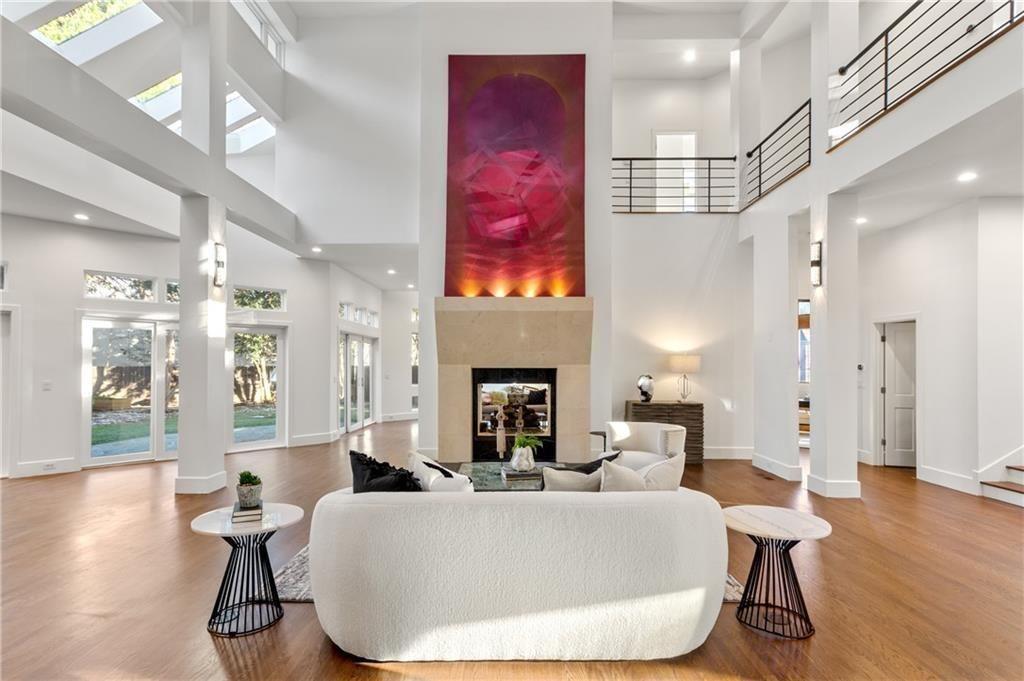 a living room with furniture a fireplace and wooden floor