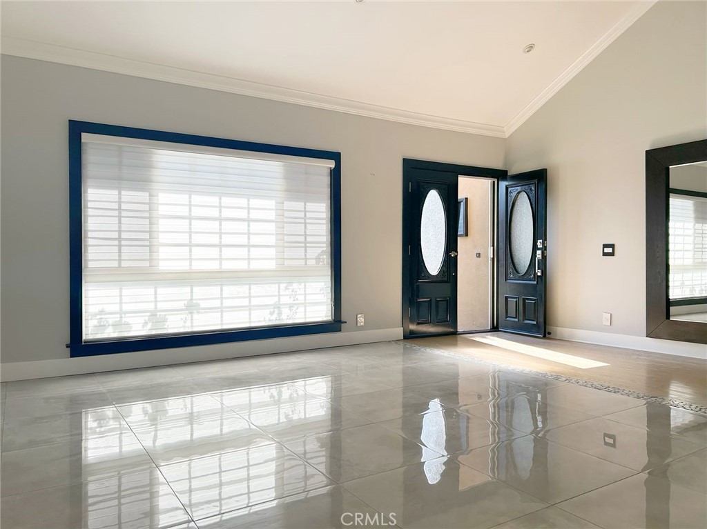 a view of an empty room with window and a fireplace