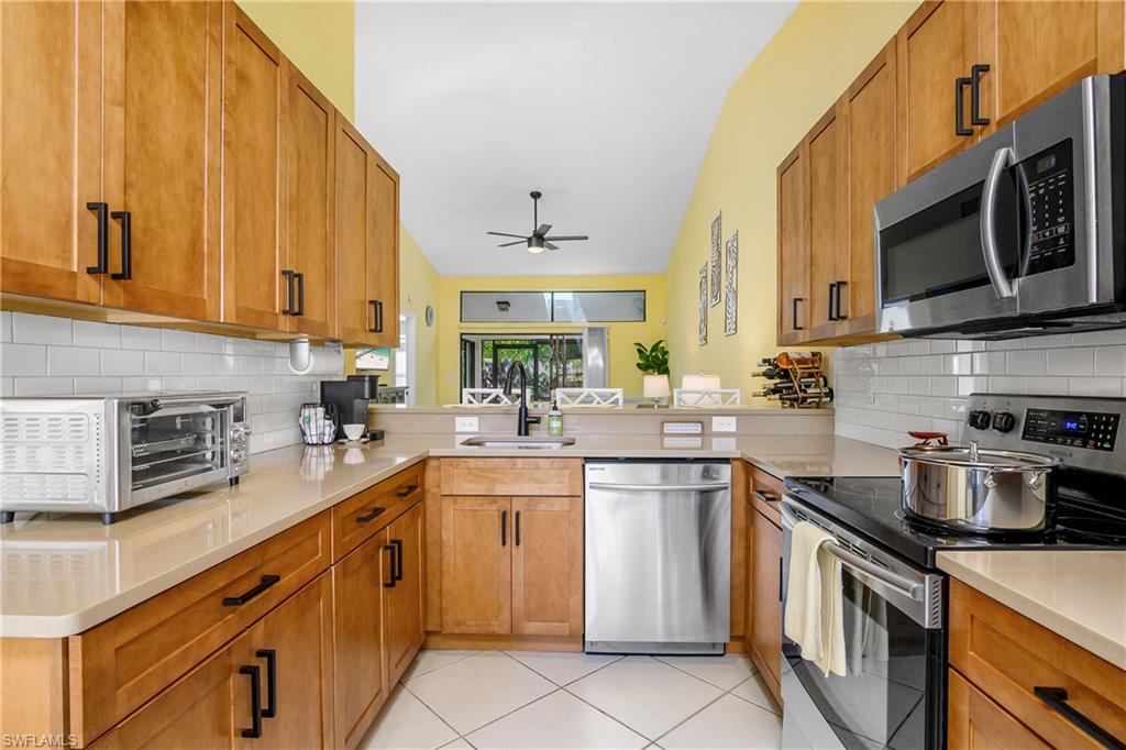 a kitchen with a sink stove and cabinets