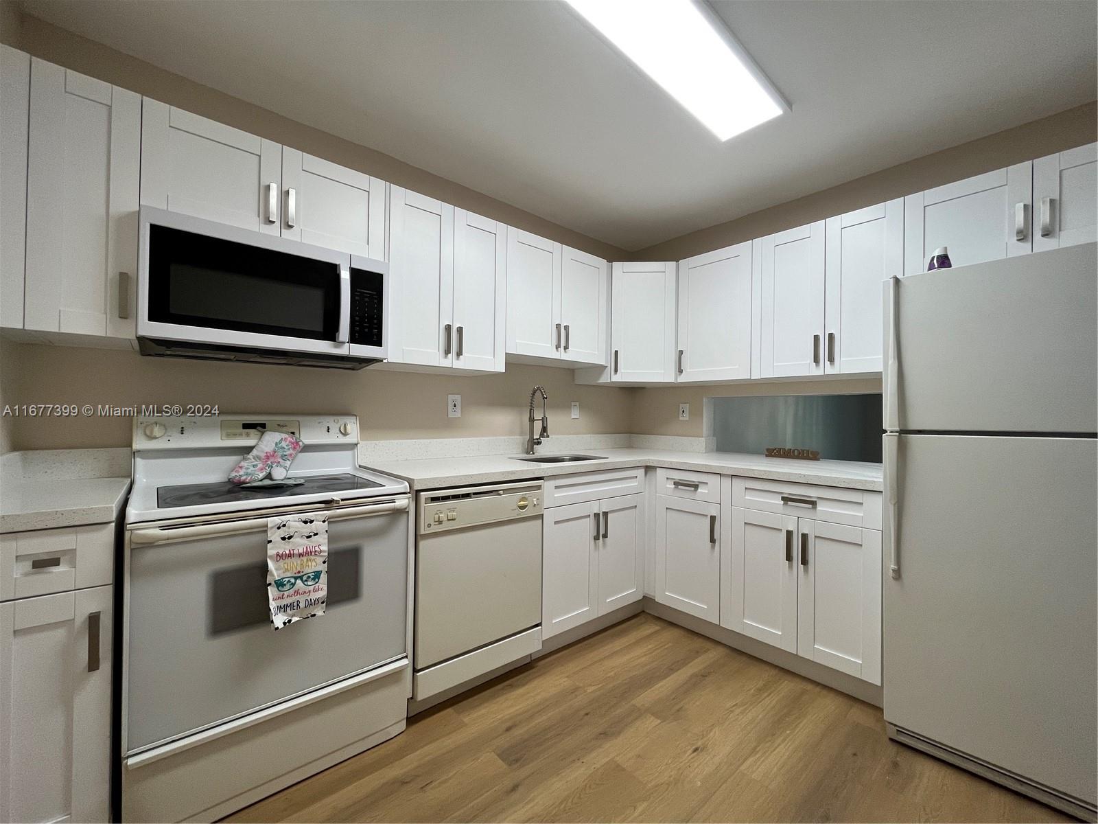 a kitchen with granite countertop cabinets stainless steel appliances and a counter space