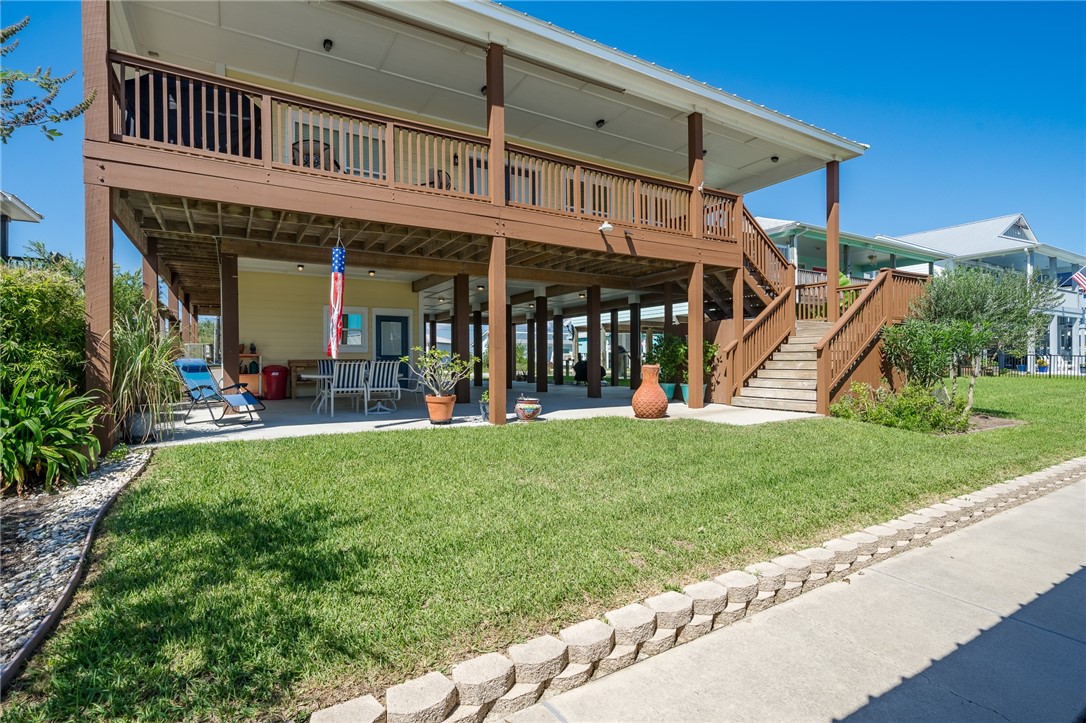 a view of a house with a yard balcony and a slide