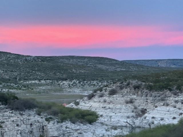 a view of sunset and green space