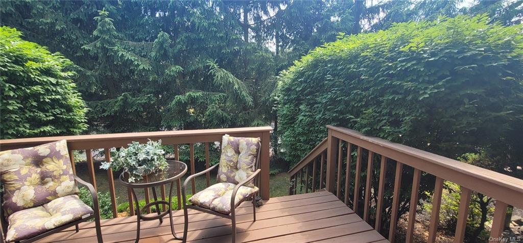 a view of balcony with wooden floor and outdoor seating