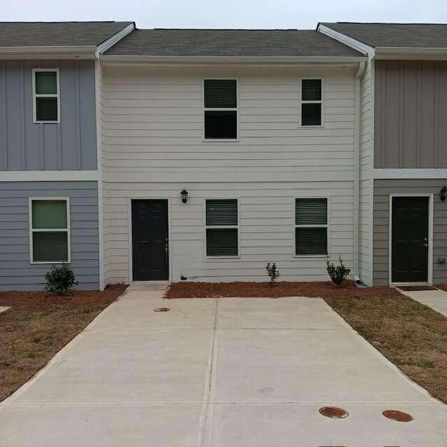 a front view of a house with yard