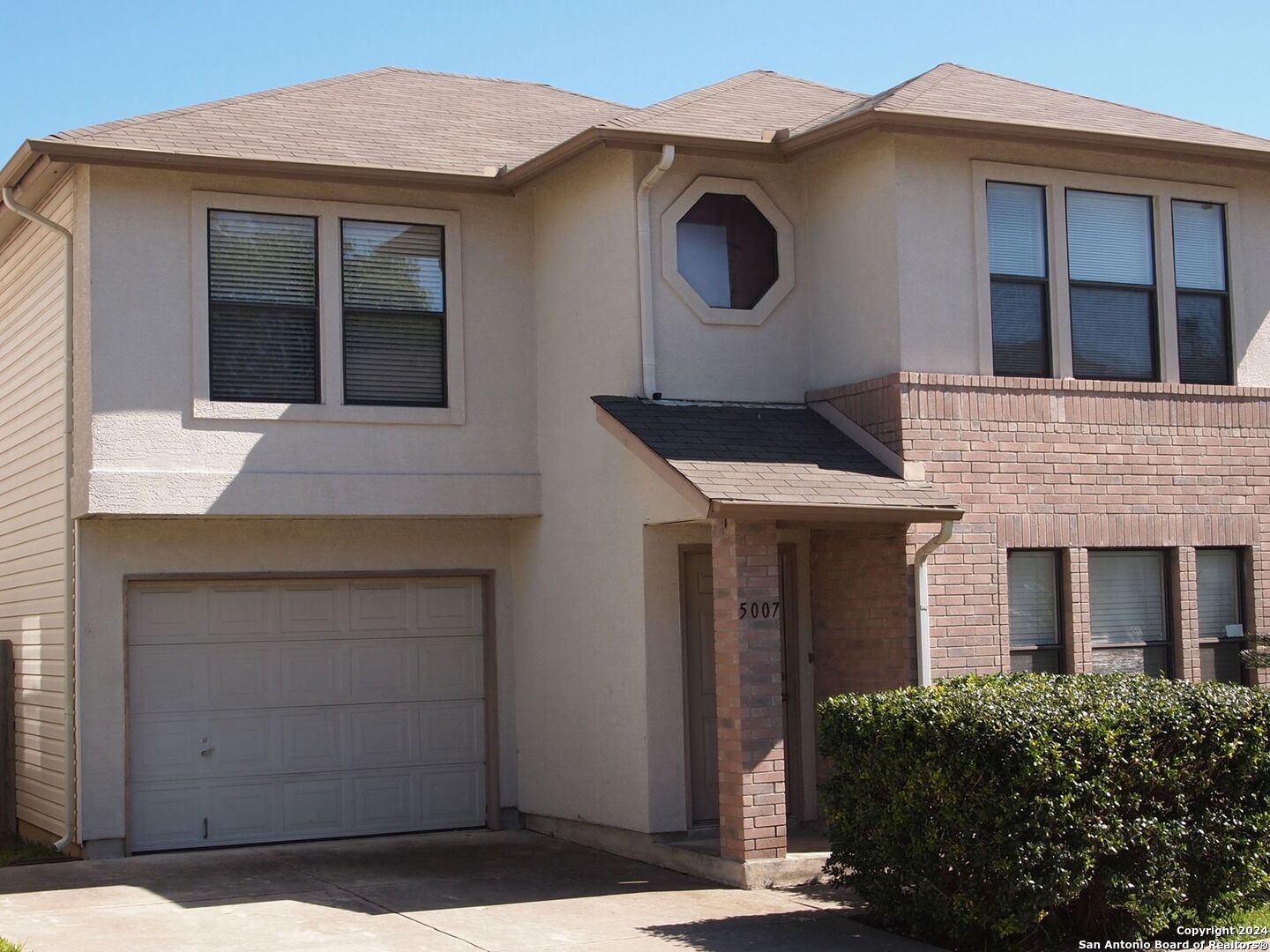 a front view of a house with a garage