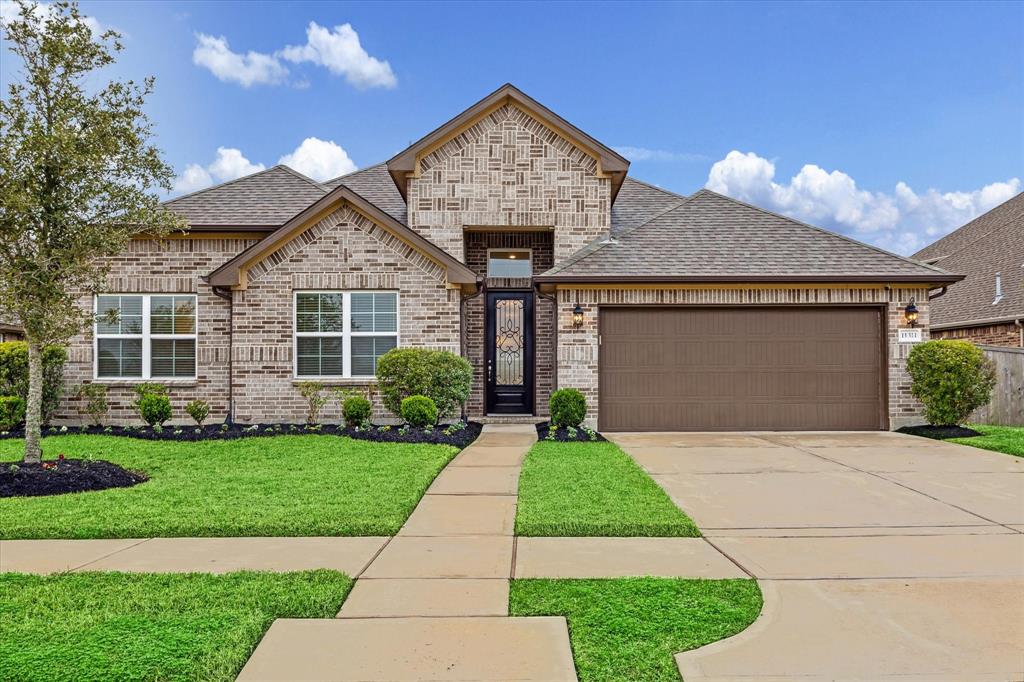 a front view of a house with a yard and garage