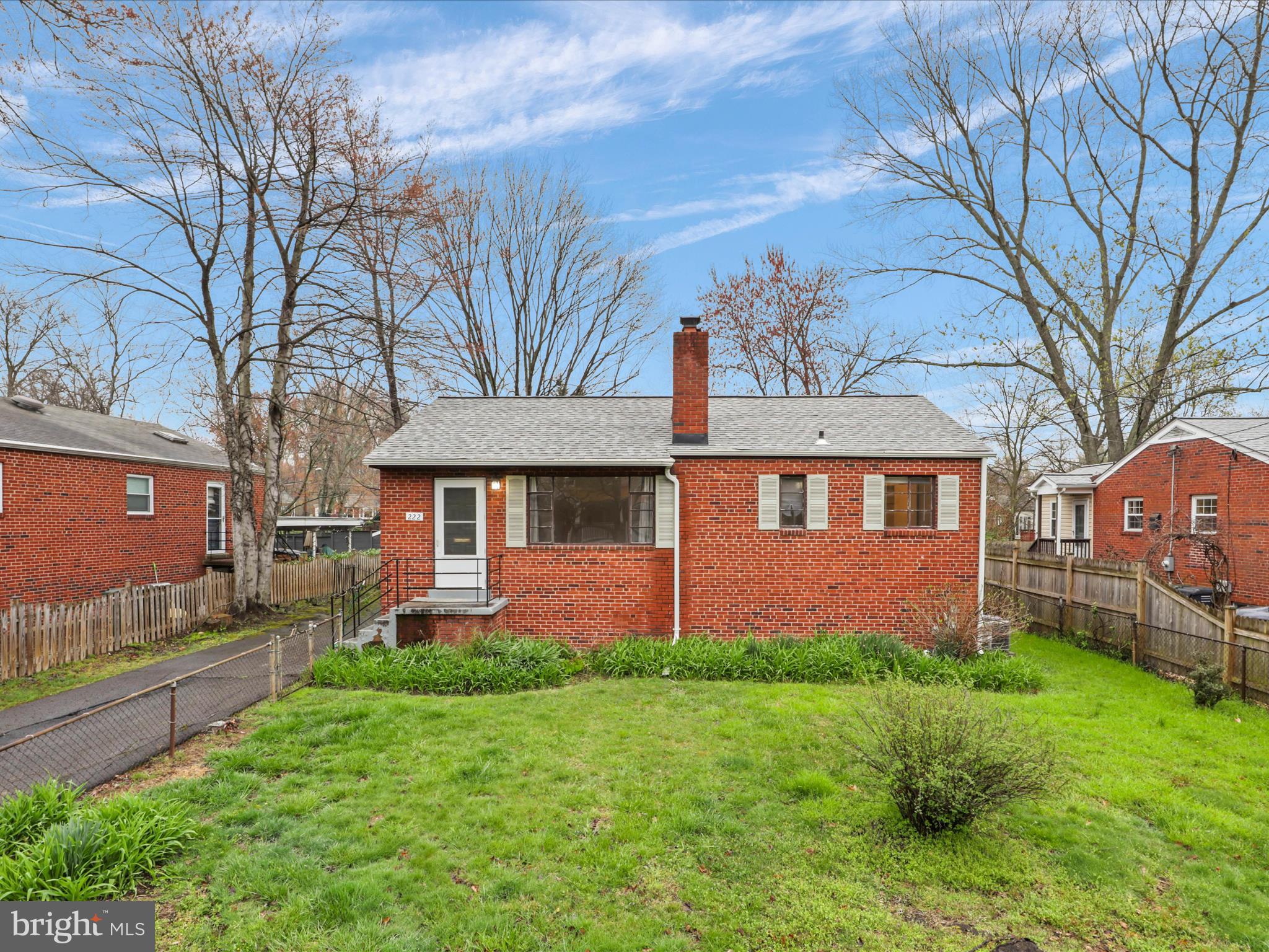 a front view of a house with a garden and yard