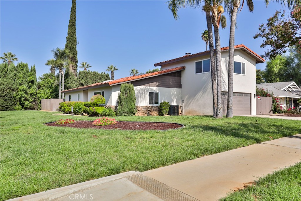 a front view of house with a garden and yard