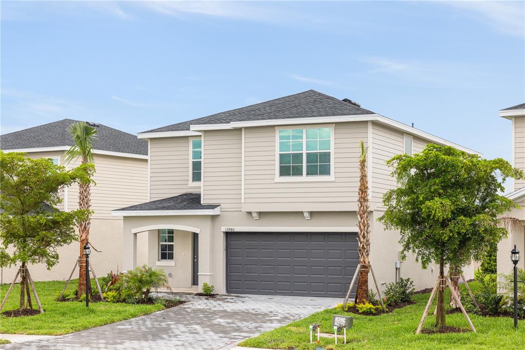 a front view of a house with a yard and garage