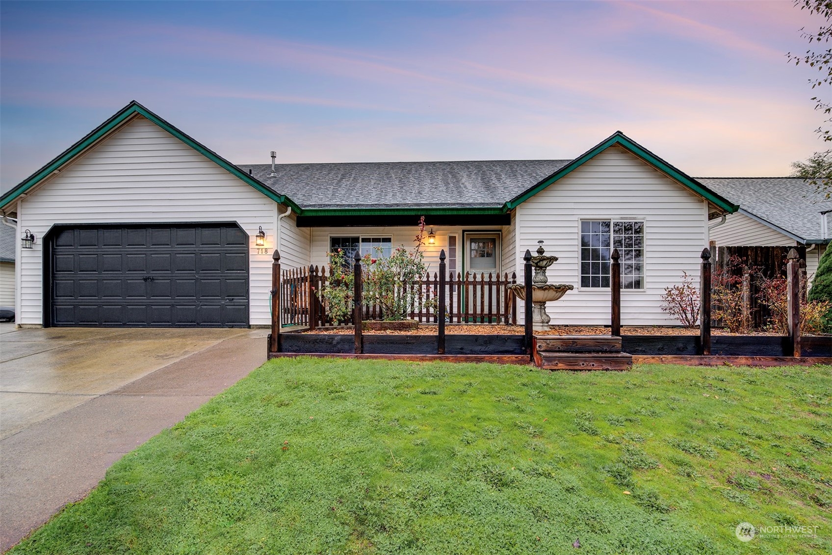 a view of a house with a yard and porch