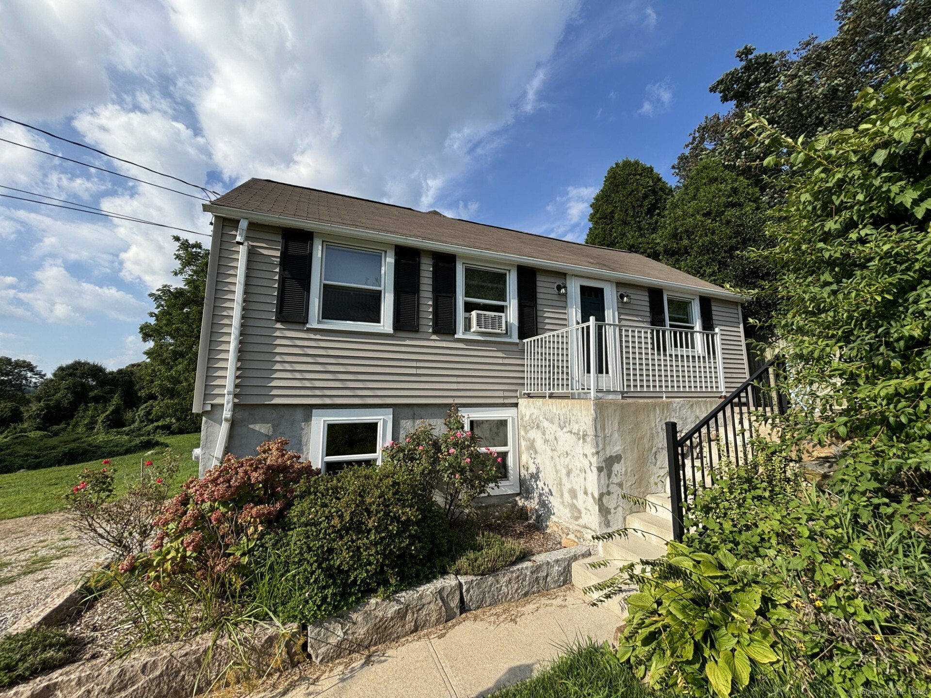 a front view of a house with garden