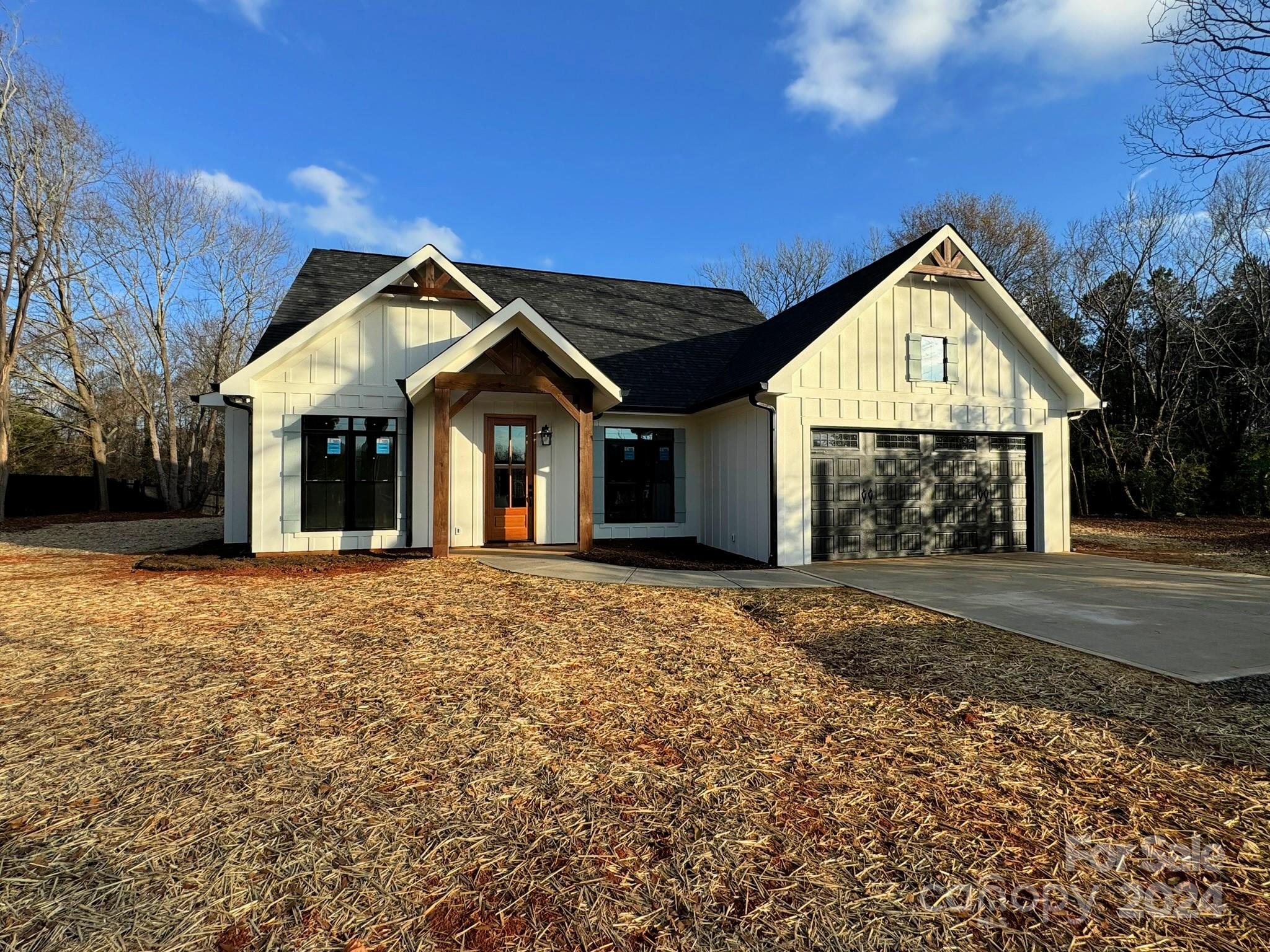 a view of a house with a yard and garage