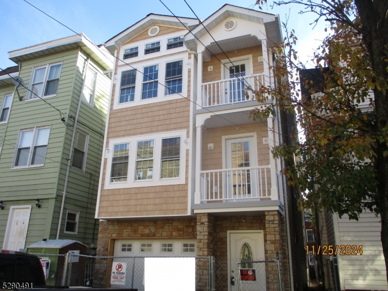 a front view of a residential apartment building with a yard