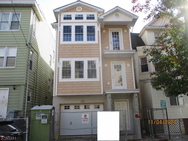 a front view of a residential apartment building with a yard