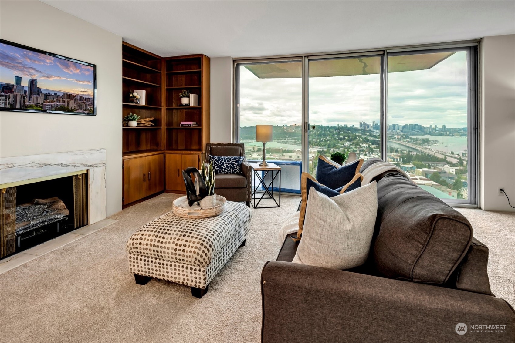 a living room with furniture fireplace and a large window