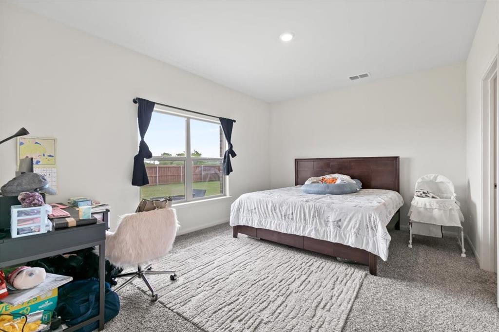 a bedroom with a bed a window and glass door