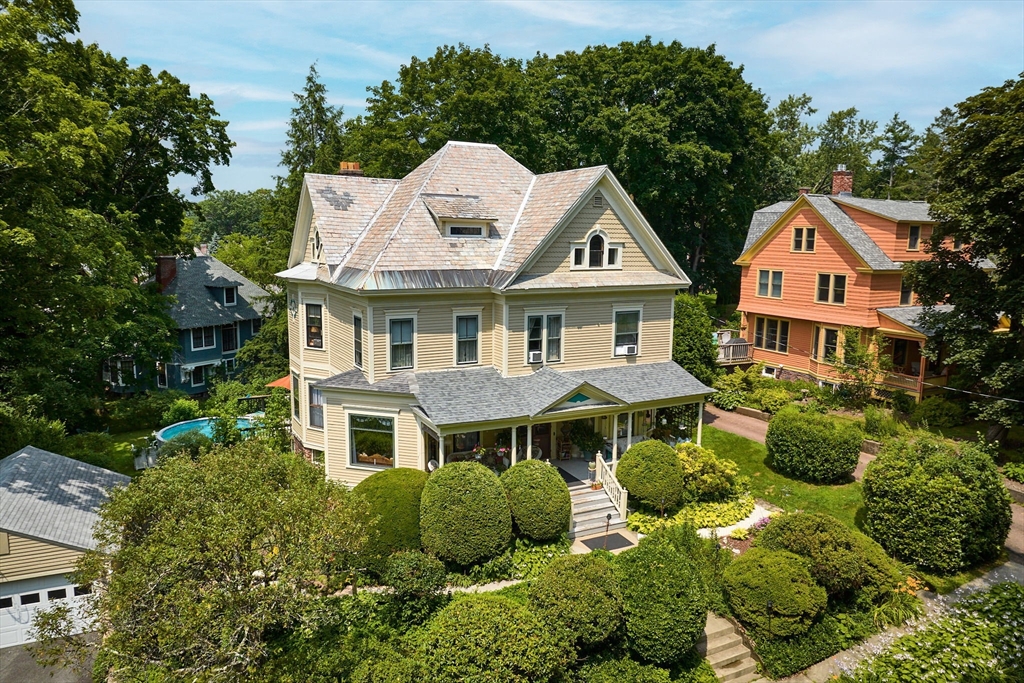 a aerial view of a house with a yard and potted plants