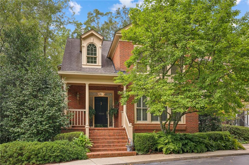 front view of a house with a tree