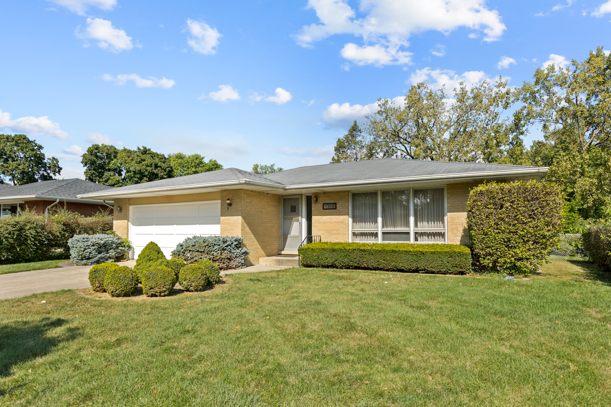 a front view of a house with garden