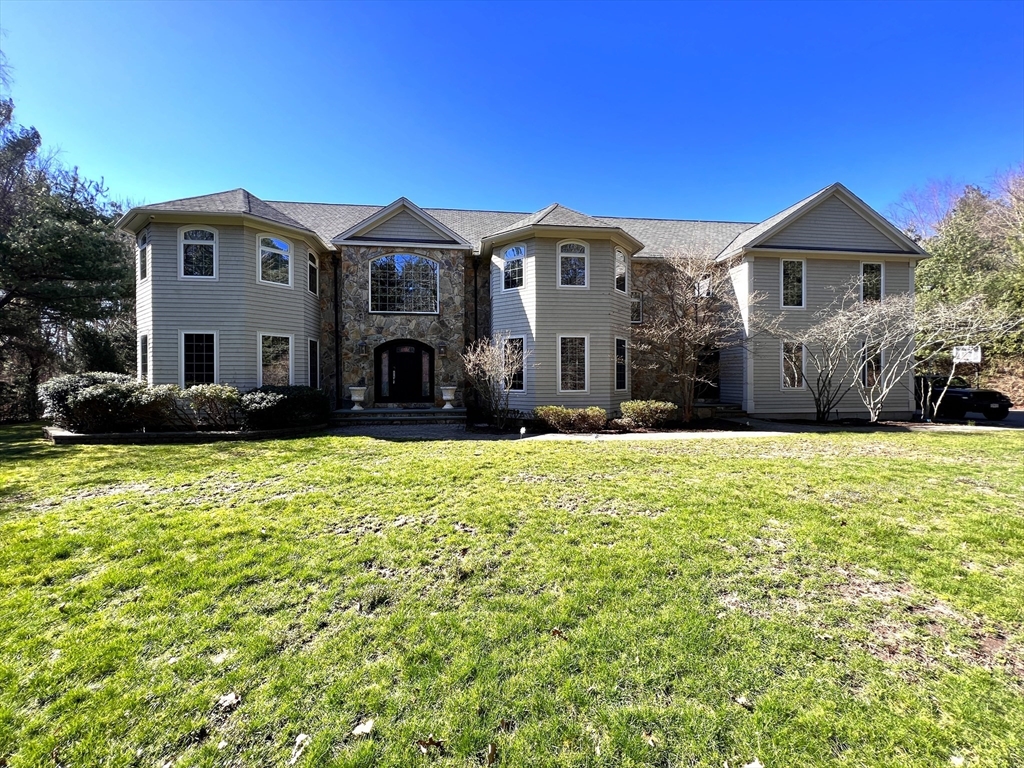 a front view of a house with a yard