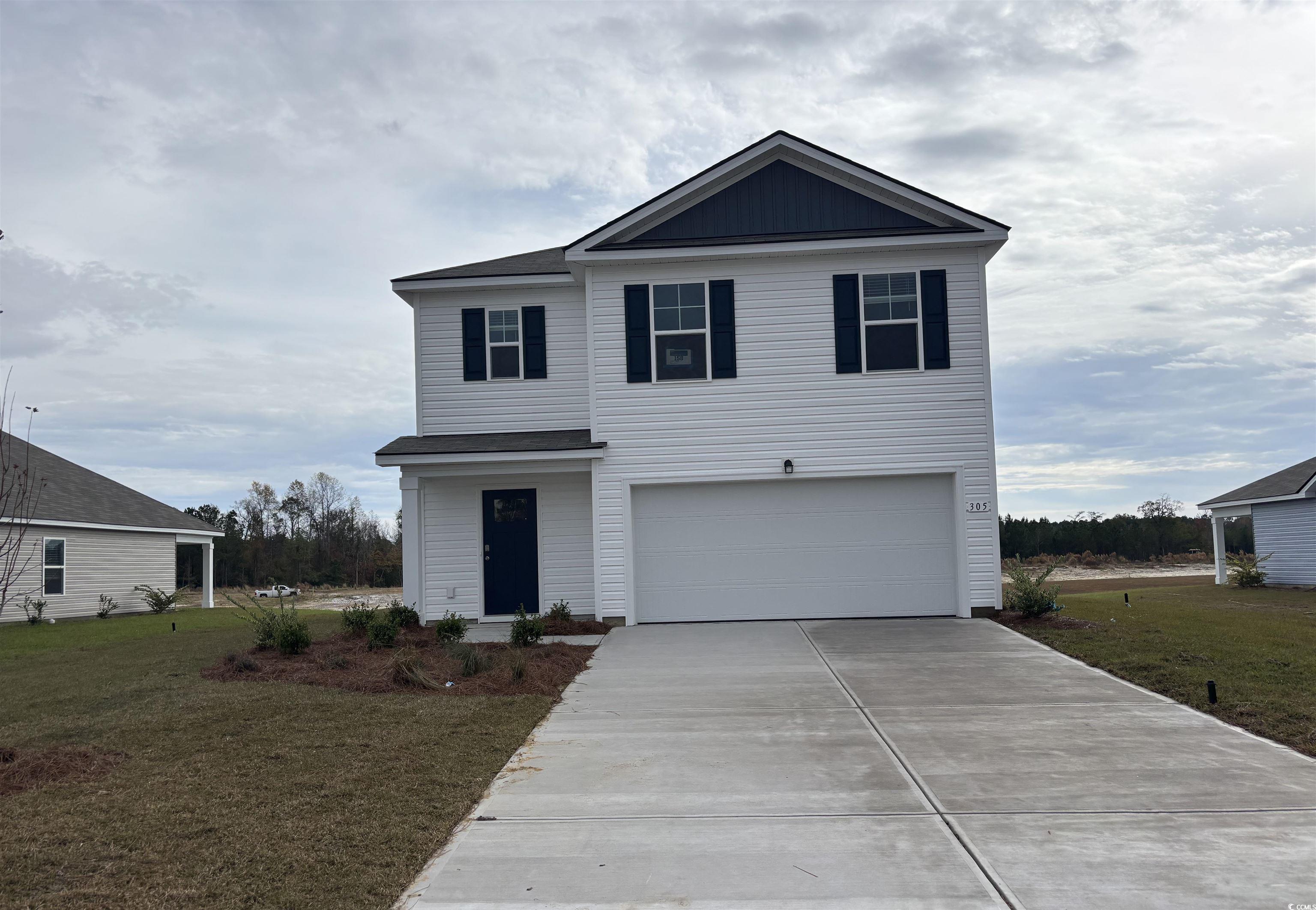 Front facade with a garage and a front yard