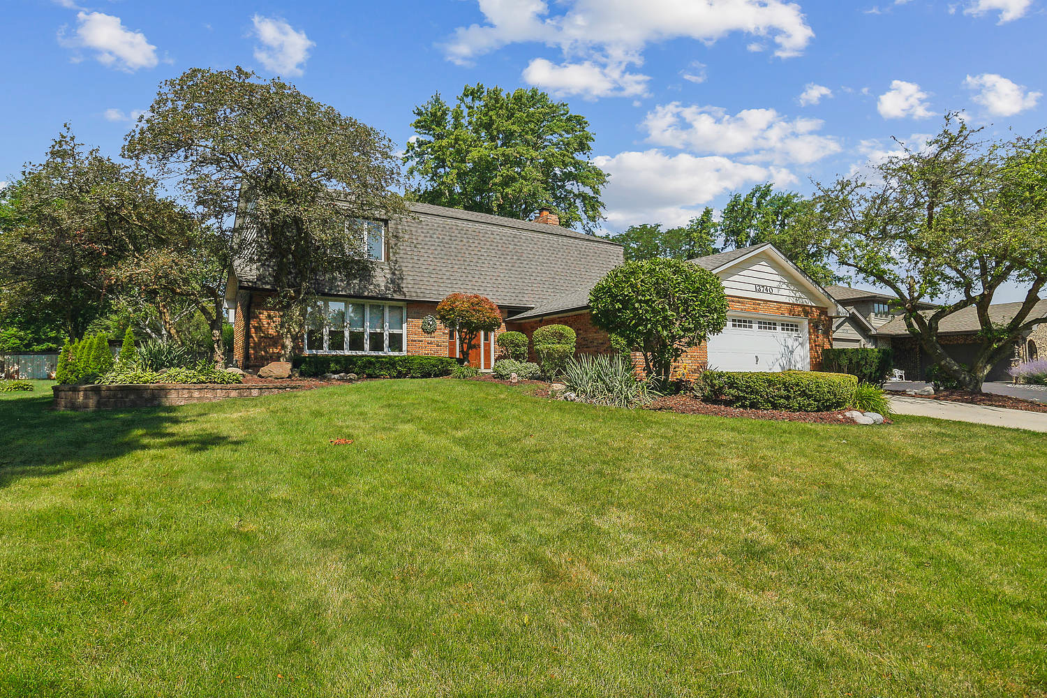 a view of house with backyard and trees