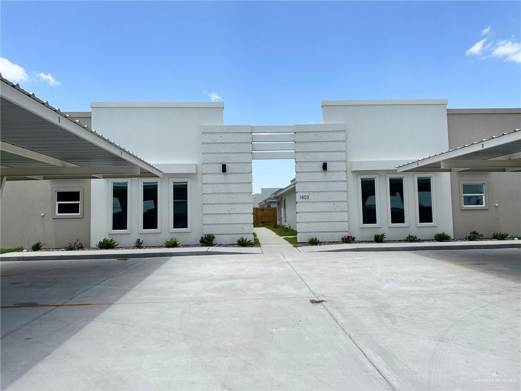 a front view of a building with a sitting area