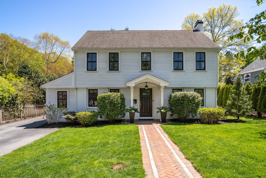 a front view of a house with a yard