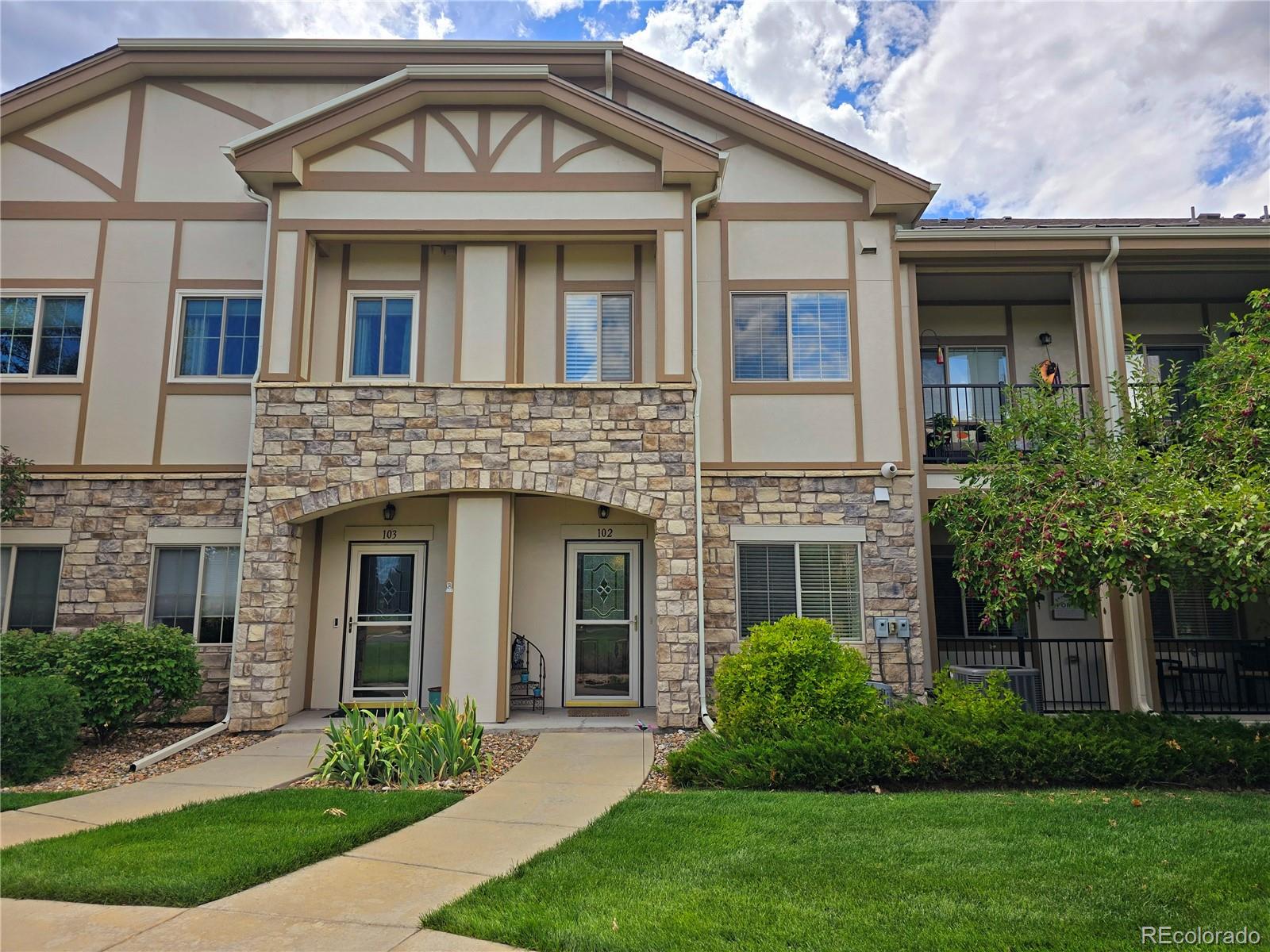 a front view of a house with garden