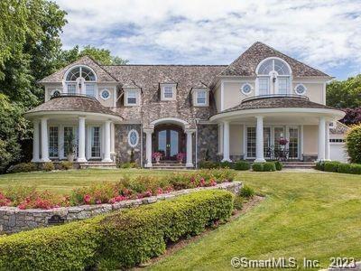 front view of a brick house with a yard