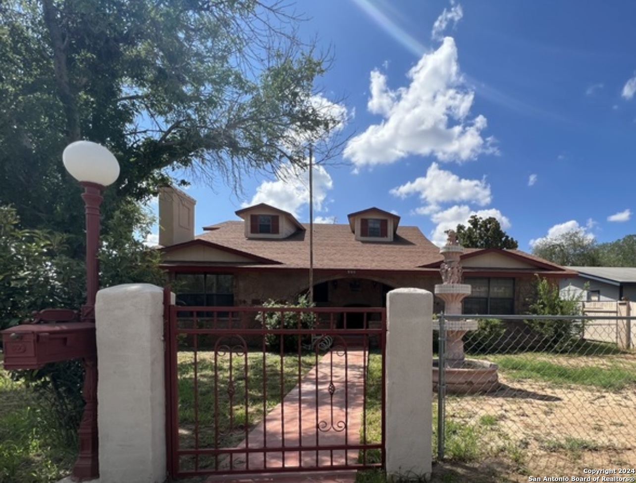 a front view of house with yard and trees