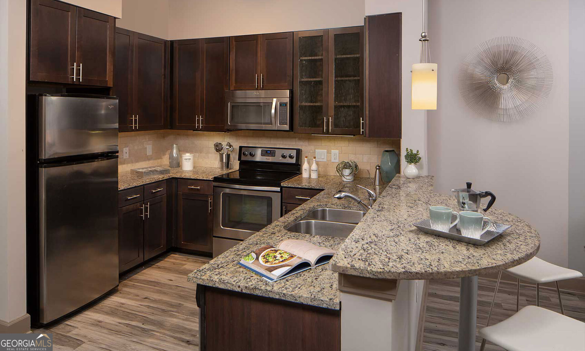 a kitchen with granite countertop stainless steel appliances and wooden cabinets