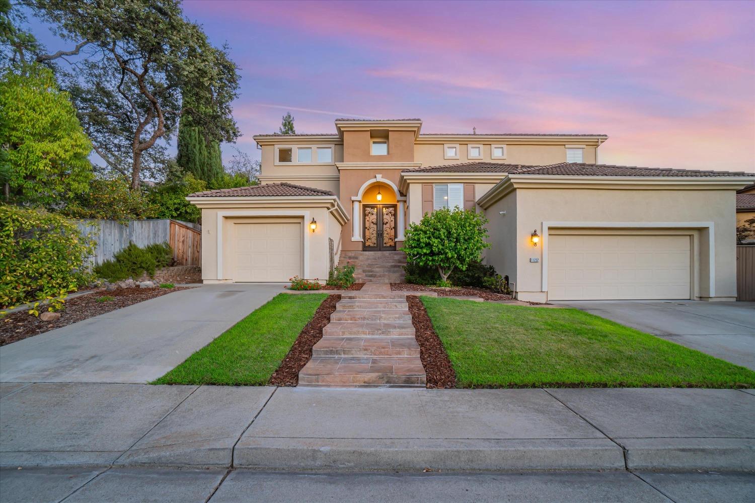 a front view of a house with a yard and a garage