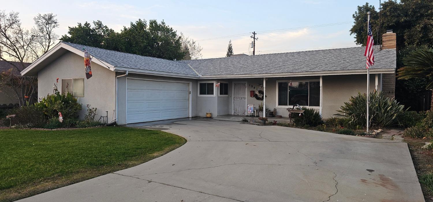 a front view of house with yard and green space