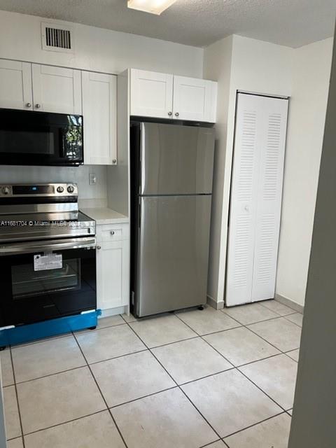 a kitchen with a refrigerator a stove and a sink