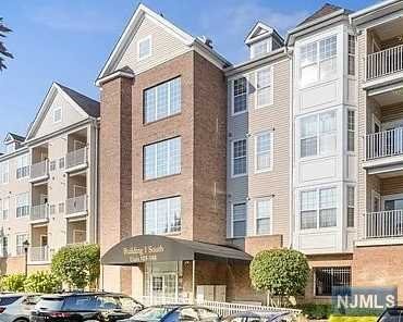 a front view of a residential apartment building with a yard