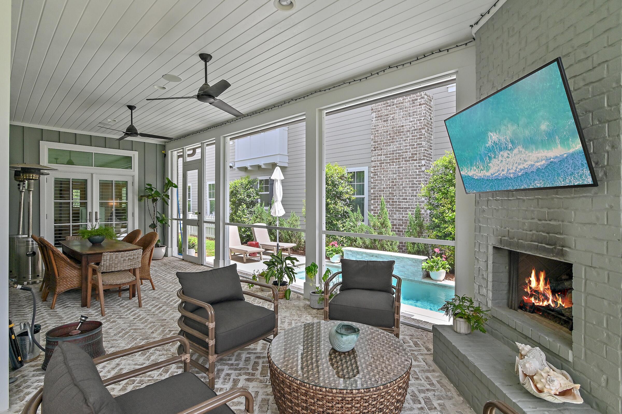 a living room with furniture a fireplace and a large window