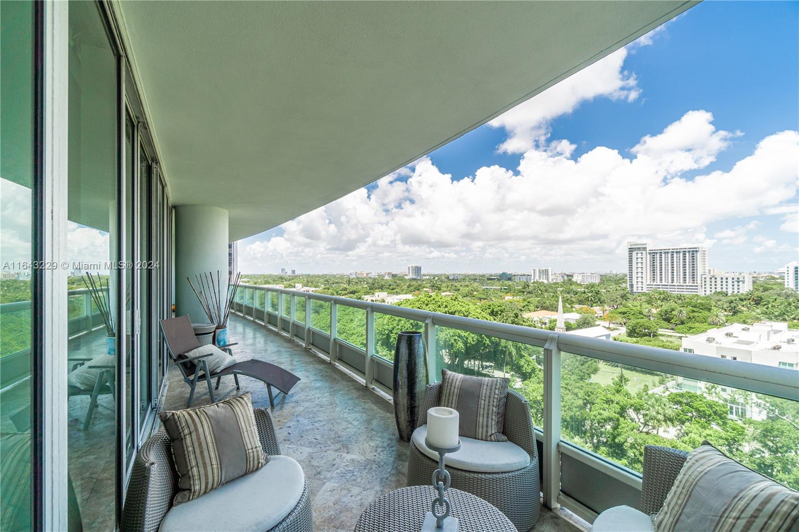 a view of a balcony with couches and wooden floor