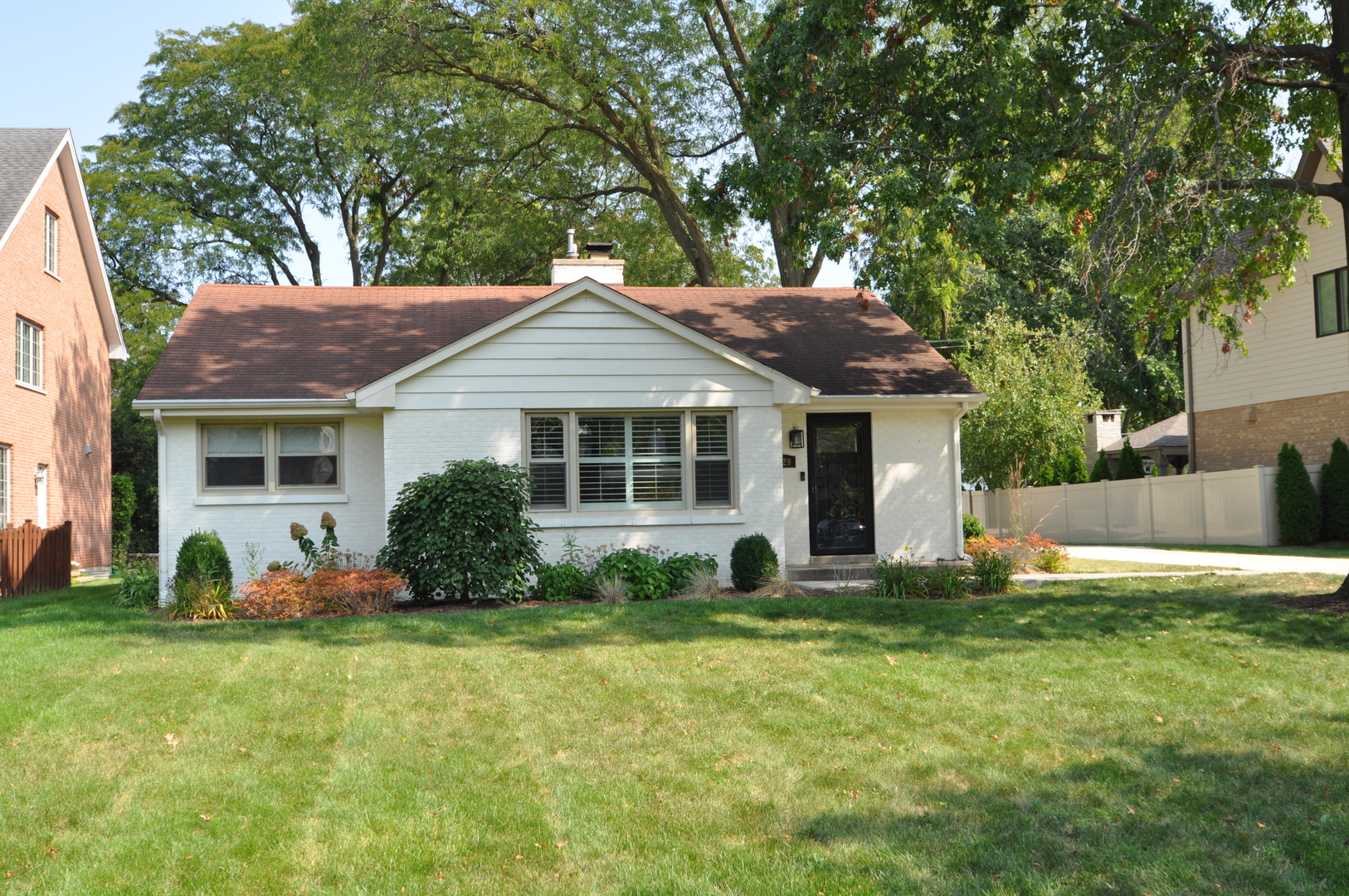 a view of a house with a yard and tree s