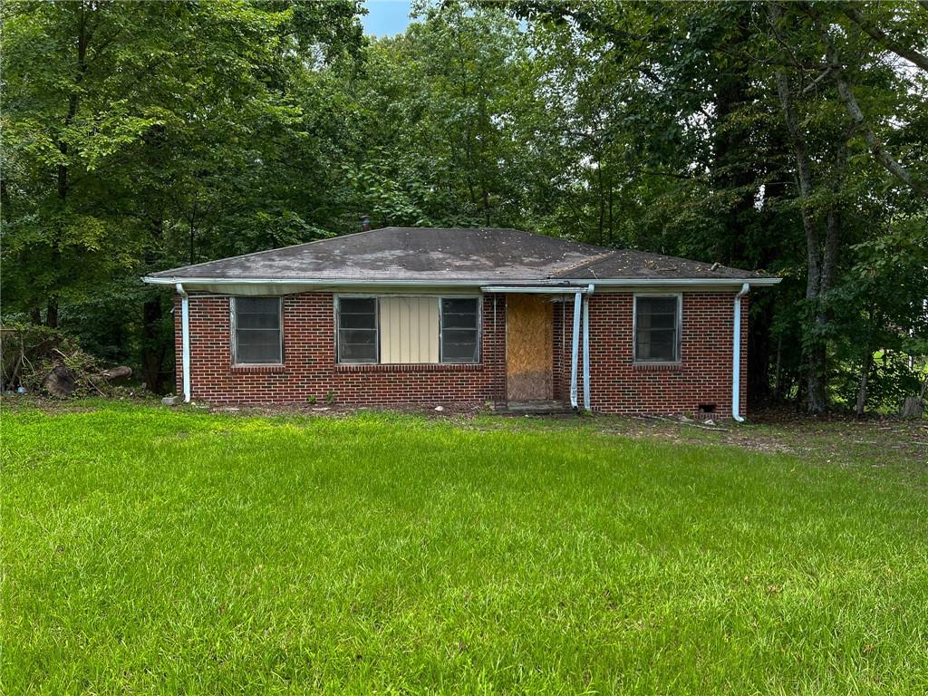 a front view of house with yard and green space