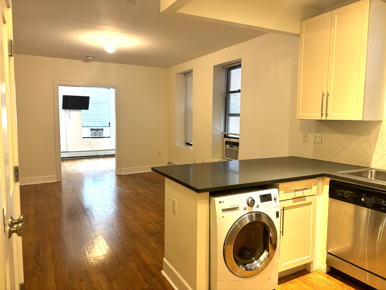 a view of a hallway with washer and dryer