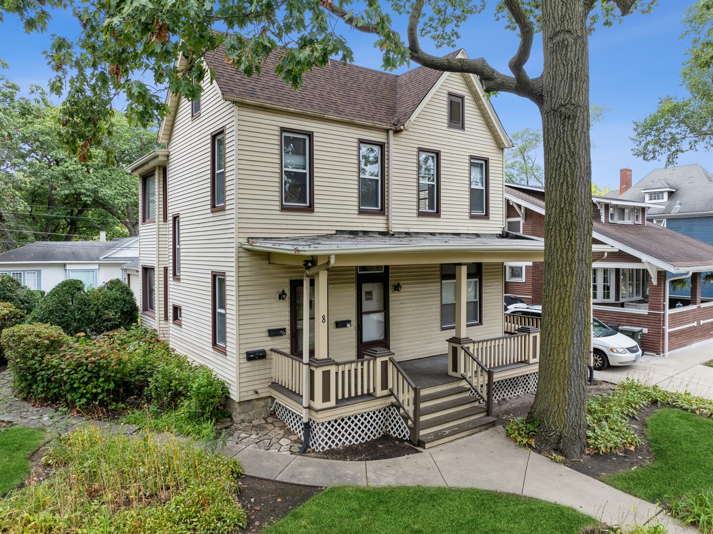 a view of house with a yard and potted plants