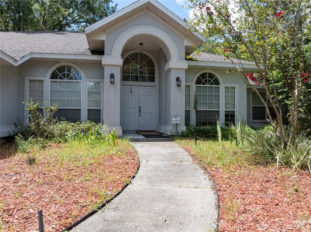 a front view of a house with garden