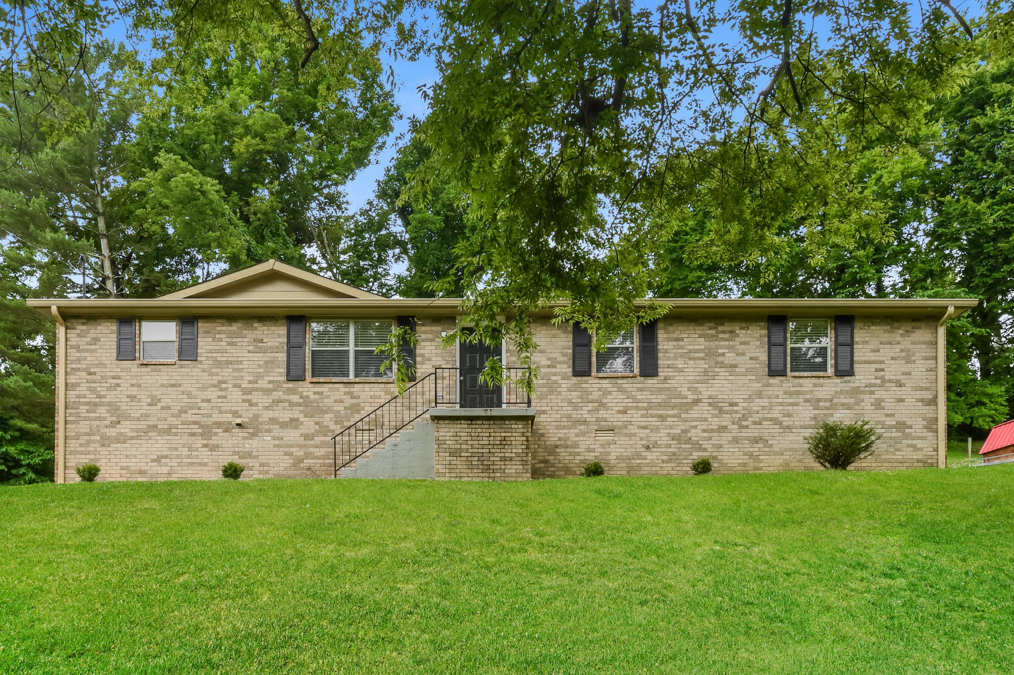 a front view of a house with a yard